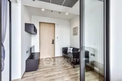 Modern small living room with wooden flooring and sleek furniture