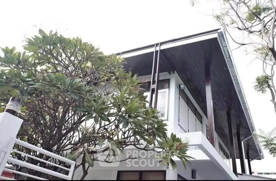 Modern architectural house exterior with sleek design and lush greenery