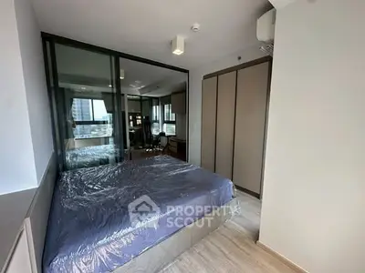 Modern bedroom with glass partition and city view in a stylish apartment