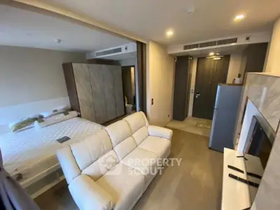 Modern studio apartment with cozy living area and stylish bedroom setup.
