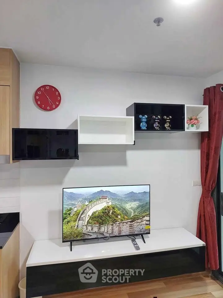 Modern living room with wall-mounted TV and stylish shelving
