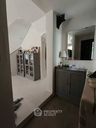 Charming interior with modern decor and ample natural light, featuring sleek cabinetry and elegant flooring.