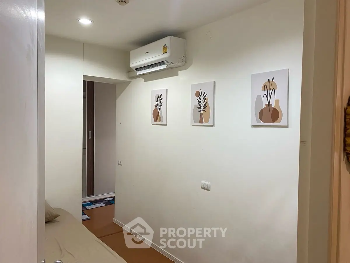 Cozy hallway with modern art and air conditioning in a stylish apartment.