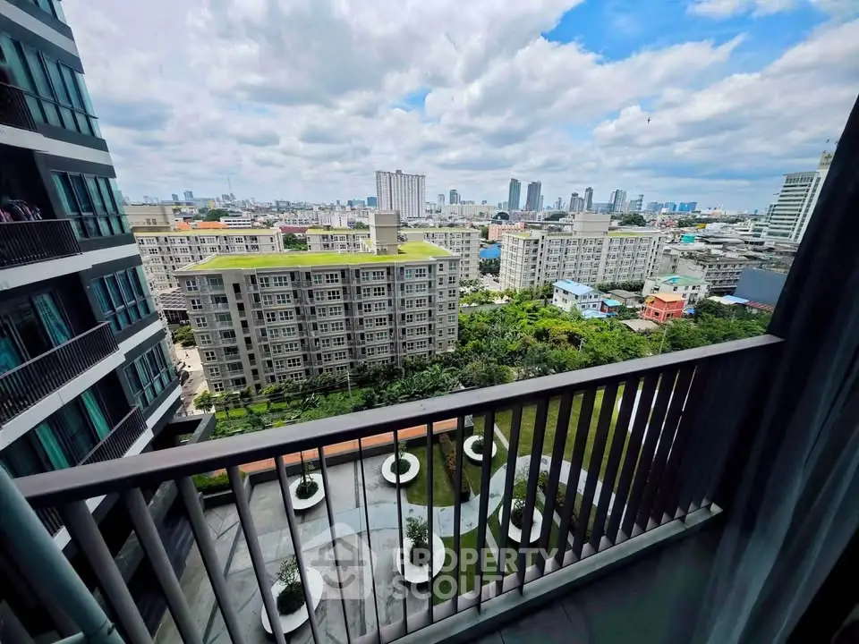Stunning cityscape view from a modern apartment balcony overlooking lush gardens and urban skyline.