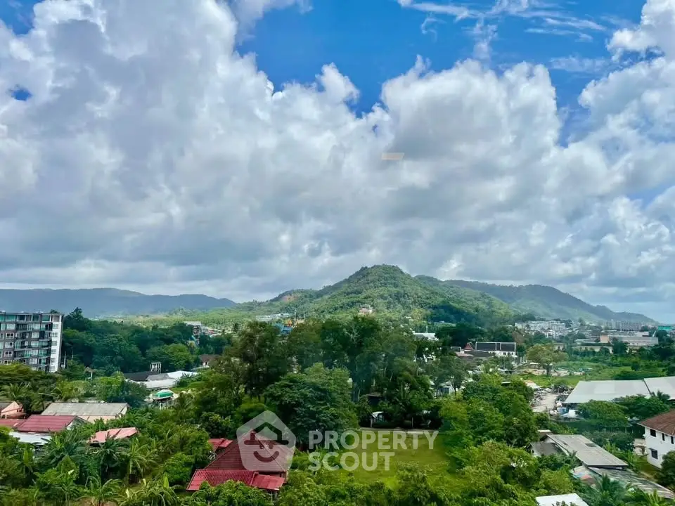 Scenic view of lush green landscape with mountains and cloudy sky, ideal for real estate development.
