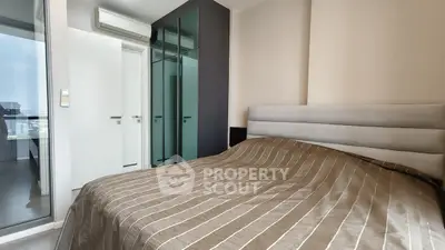 Modern bedroom with sleek design and mirrored wardrobe in a stylish apartment.