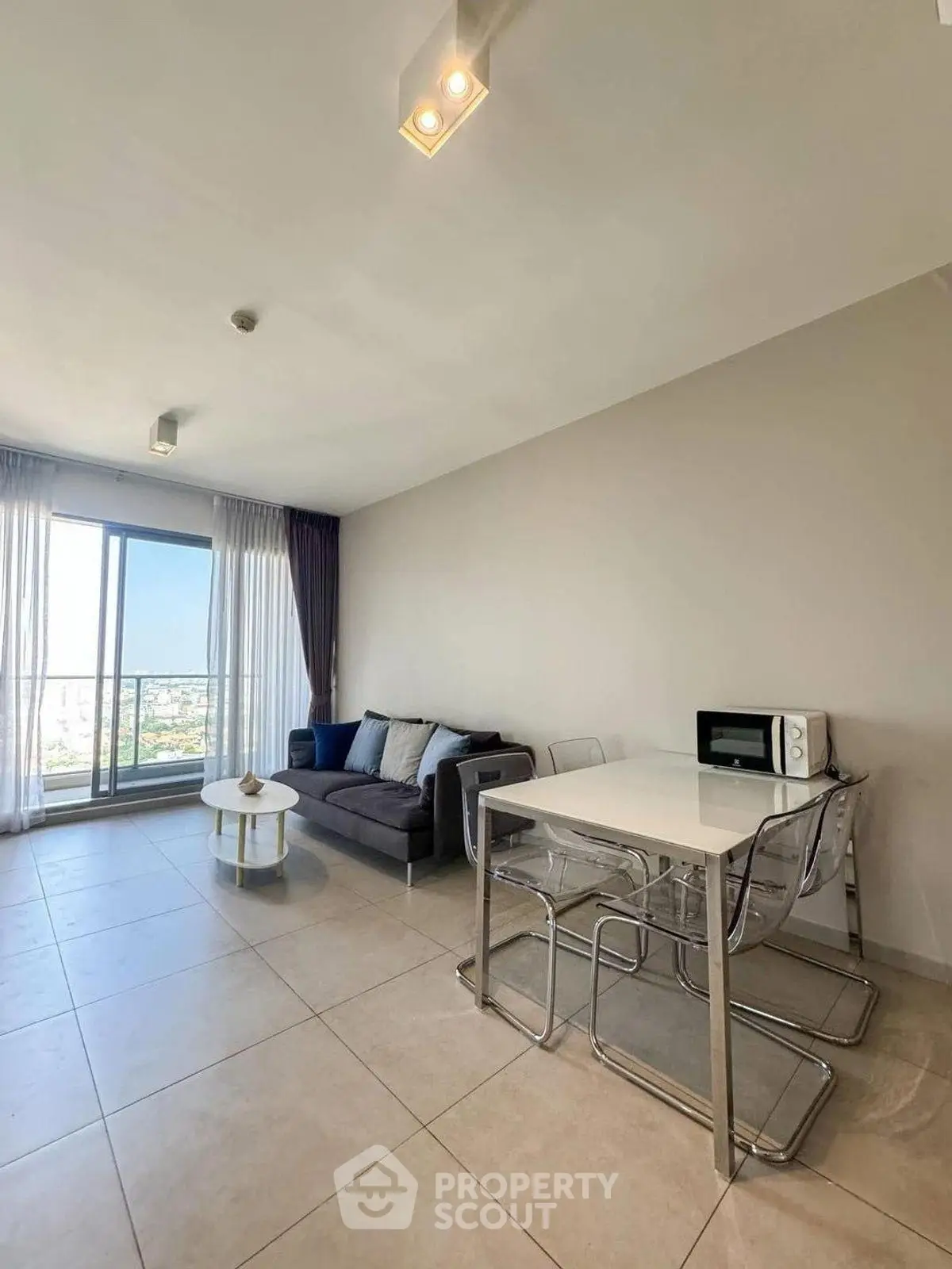 Modern living room with balcony view and sleek dining area