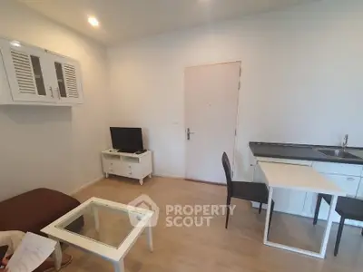 Modern compact living room with kitchenette and stylish furniture