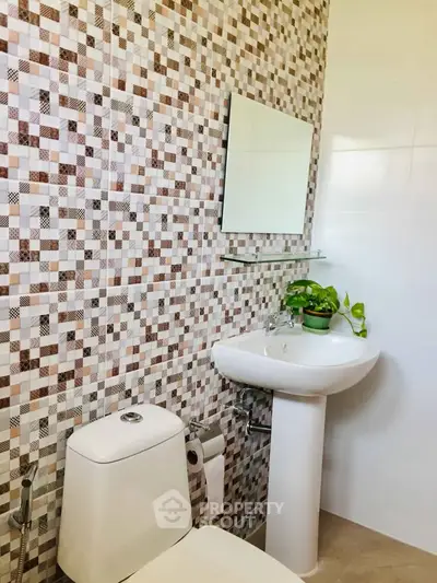 Modern bathroom with stylish mosaic tiles and sleek fixtures