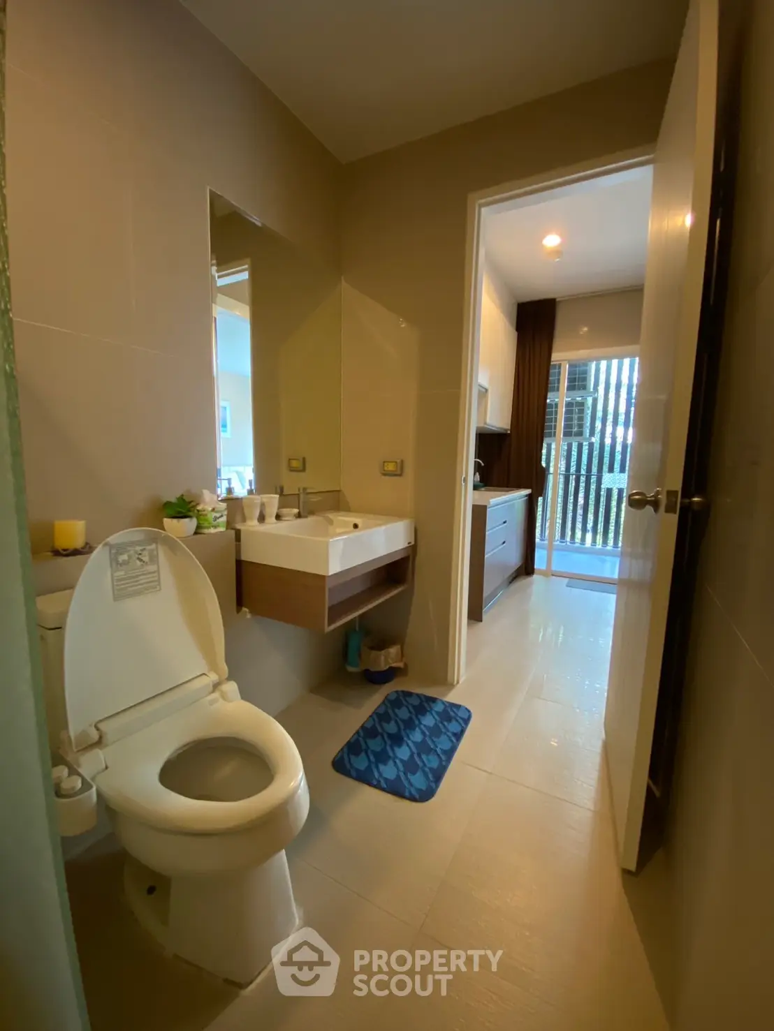 Modern bathroom with sleek fixtures and natural light, featuring a stylish sink and toilet.