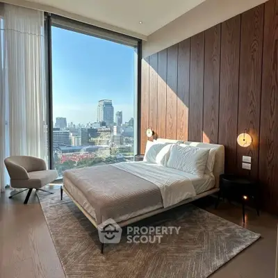 Luxurious bedroom with stunning city view and modern decor in high-rise apartment.