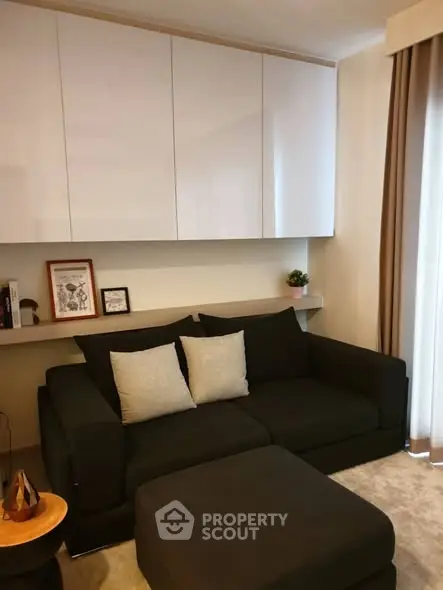 Cozy living room with modern black sofa and stylish decor
