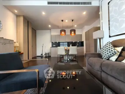 Modern living room with stylish furniture and open kitchen layout, perfect for contemporary living.