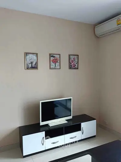 Modern living room with sleek TV stand and wall-mounted air conditioner.