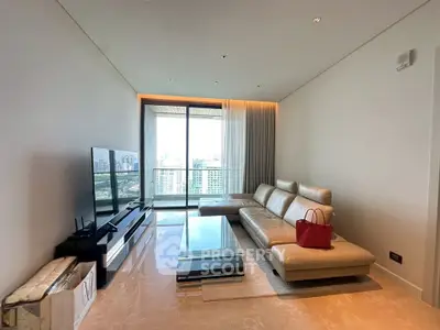 Luxurious modern living room with leather sofa and city view balcony.