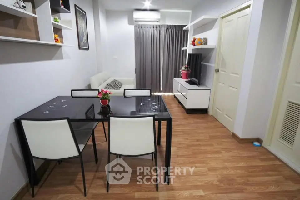 Modern living room with sleek furniture and wooden flooring, perfect for cozy gatherings.