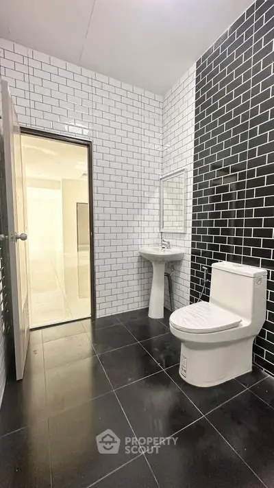 Modern bathroom with black and white tile design and sleek fixtures