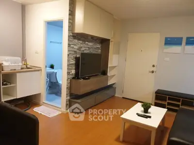 Modern living room with stylish decor and open view into adjacent bathroom