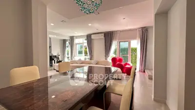 Luxurious open-plan living and dining area with elegant decor and ample natural light.