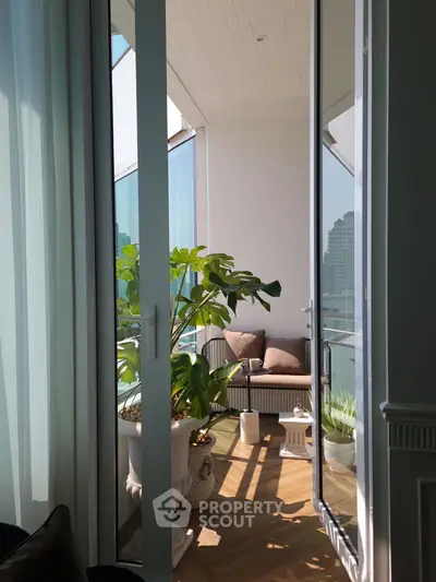 Charming balcony with cozy seating and lush plants, perfect for relaxation and enjoying city views.