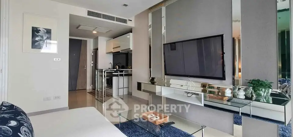 Modern living room with sleek decor and wall-mounted TV in stylish apartment.