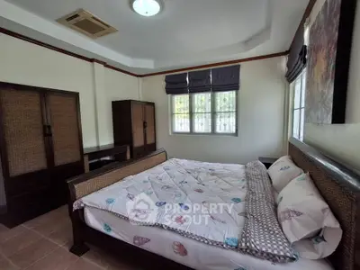 Spacious bedroom with cozy bed and ample natural light