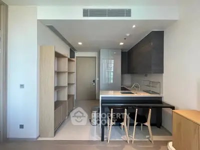 Modern kitchen with sleek design and open layout, featuring minimalist furniture and ample storage space.
