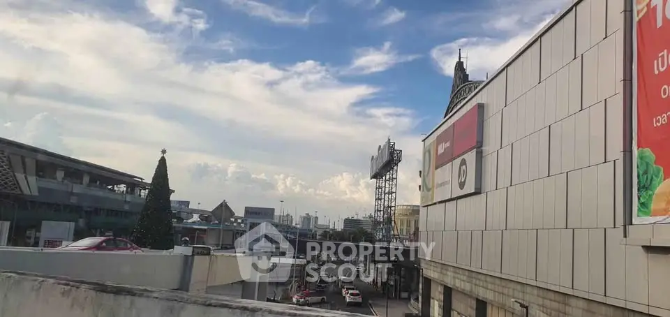 Urban cityscape view with modern buildings and clear sky, showcasing vibrant city life.