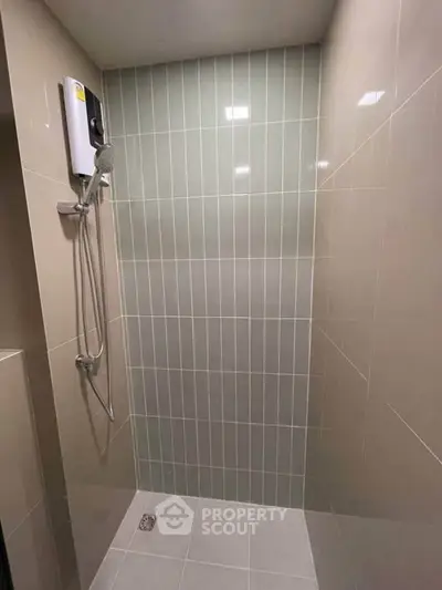 Modern bathroom with sleek shower design and neutral tile accents