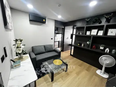 Modern living room with stylish decor and open layout, featuring a cozy sofa and elegant shelving.