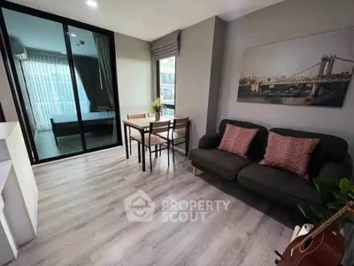 Modern living room with stylish decor and view into cozy bedroom