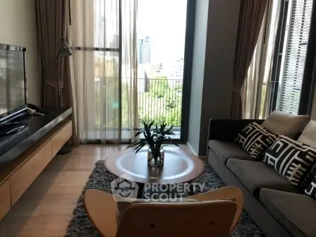 Stylish living room with modern decor and large windows offering city views.