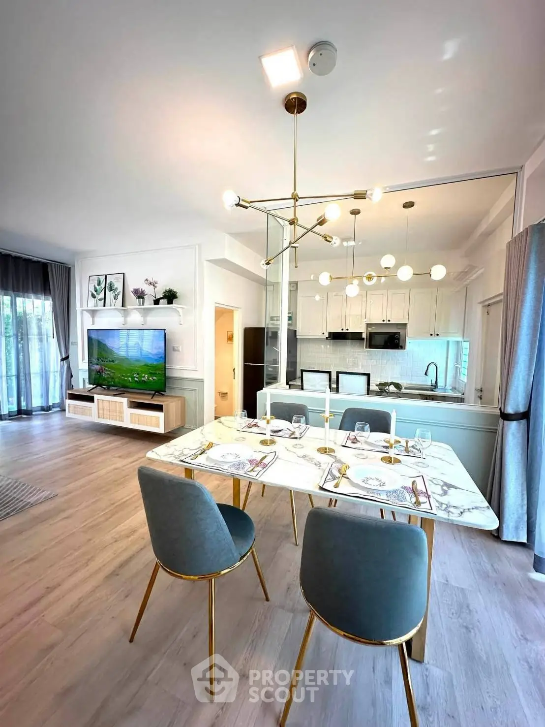 Luxurious open-plan living and dining area with modern kitchen and elegant decor.