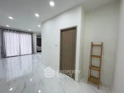 Spacious modern living area with elegant marble flooring and natural light.
