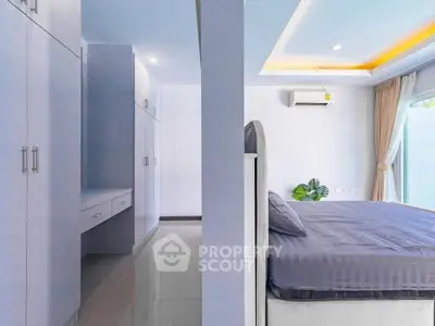 Spacious modern bedroom with built-in wardrobe and natural light