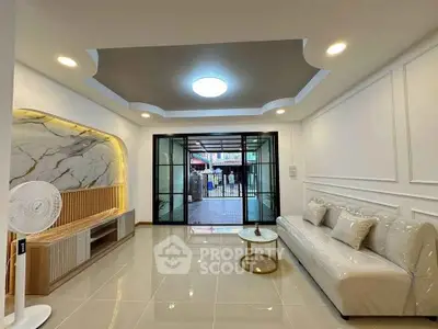 Elegant living room with modern design and large glass doors opening to a patio.