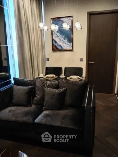 Elegant living room with plush sofa and modern lighting in a stylish apartment.