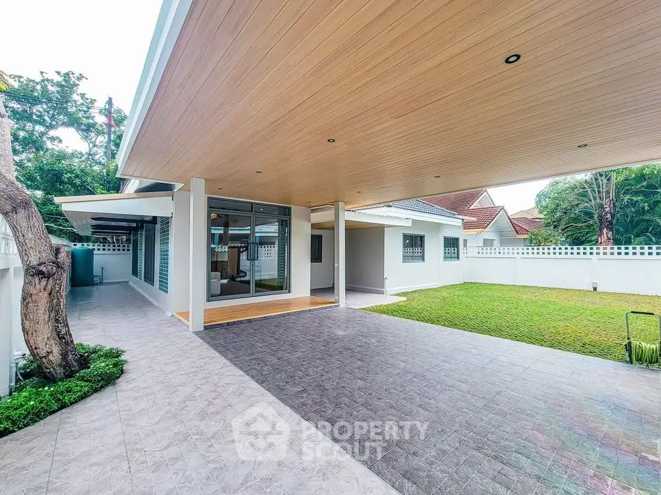 Modern home exterior with spacious patio and lush garden