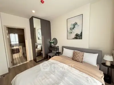 Modern bedroom with stylish decor and ample natural light, featuring a cozy bed and elegant furnishings.