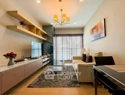 Modern living room with stylish decor and natural light, featuring a cozy sofa and elegant shelving.