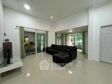 Spacious living room with modern decor and large windows for natural light.