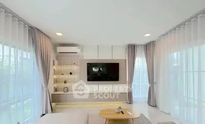 Spacious modern living room with large windows and elegant decor