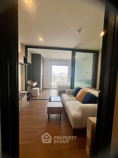Modern living room with stylish furniture and large windows offering a bright and airy atmosphere.