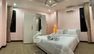 Spacious bedroom with modern decor and ample natural light, featuring a cozy bed and sleek wardrobe.