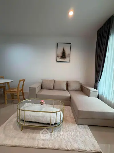 Modern living room with stylish beige sofa and elegant coffee table, perfect for cozy gatherings.