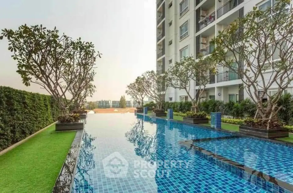 Luxurious apartment building with stunning pool and lush greenery