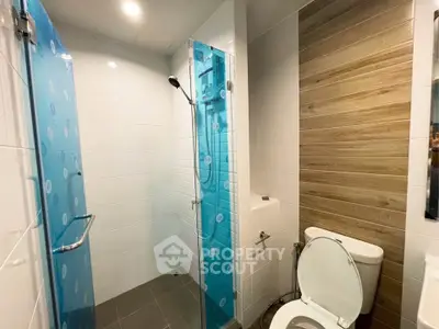 Modern bathroom with glass shower and wood accent wall