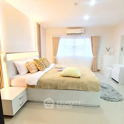 Spacious and bright bedroom with modern decor and large window