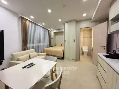 Modern studio apartment with cozy living area and compact kitchen