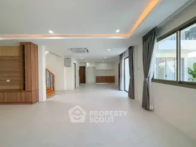 Spacious modern living room with elegant lighting and large windows